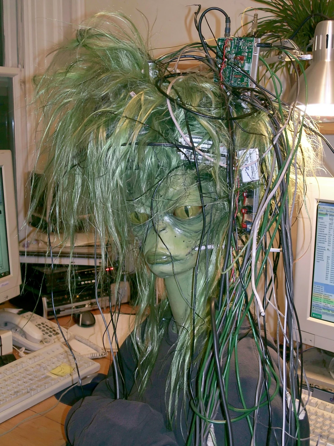 Chlorophyll polyhybrid with green hair, reptilian eyes, and extensive cybernetic augmentation